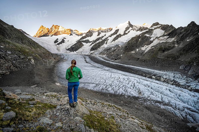 Mountaineer standing in front of glacier