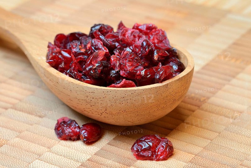 Dried cranberriesin wooden ladle