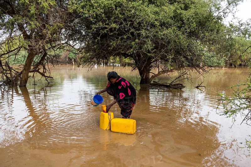 Woman fetches water in canisters
