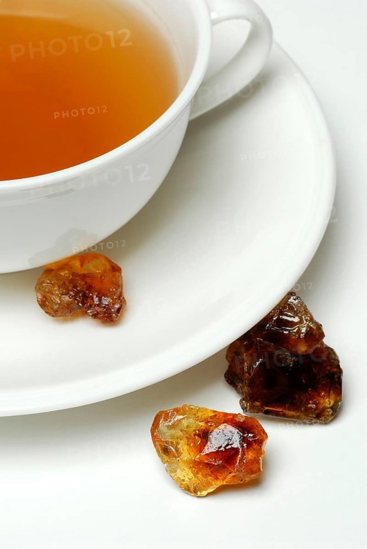 Cup of tea and brown rock candy