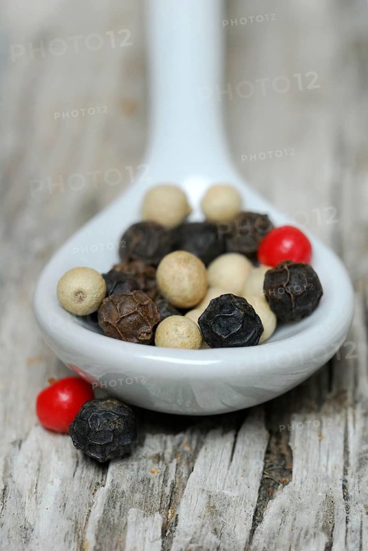 Peppercorns in porcelain spoon