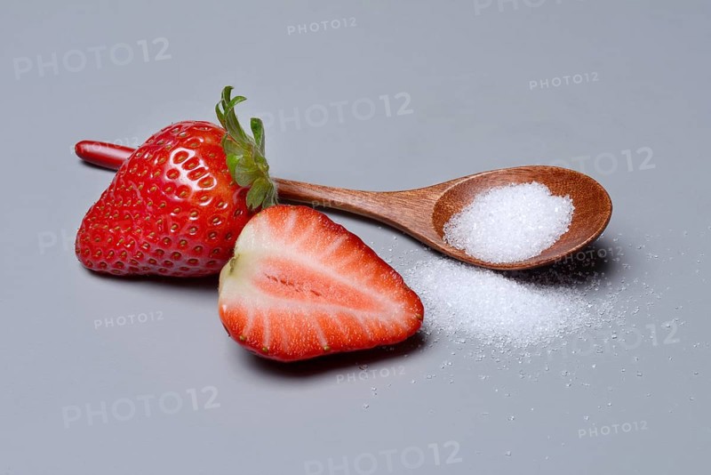 Strawberries and sugar with spoon