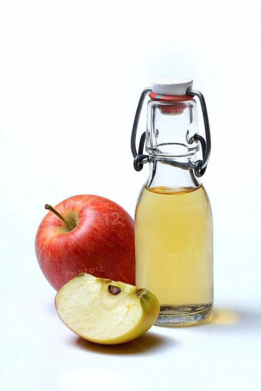 Bottle with apple vinegar and apples