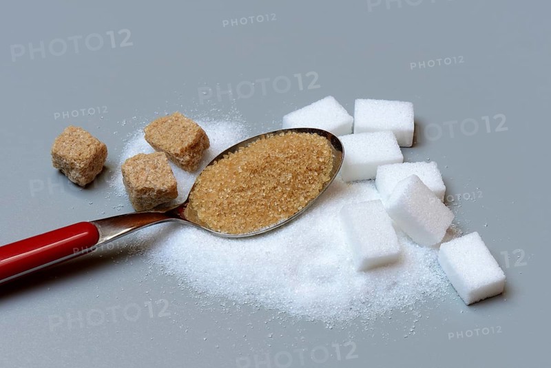 Spoon with cane sugar and white sugar