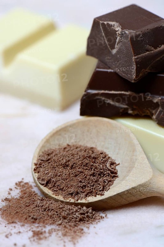 Grated chocolate blocks in cooking spoon