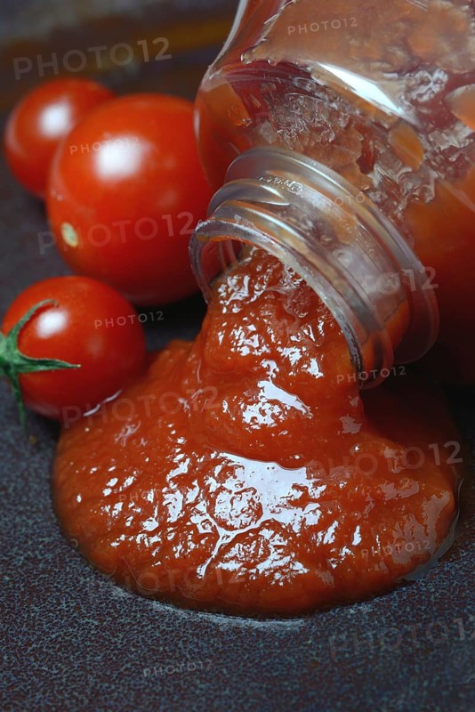 Tomato ketchup flows from bottle