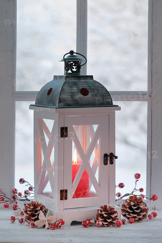 Lantern with Christmas decoration on windowsill