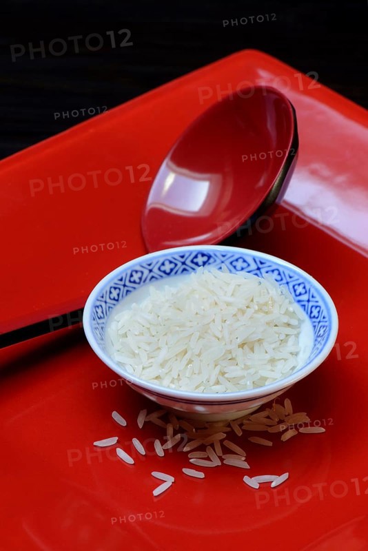 Rice grains in bowls and chopsticks