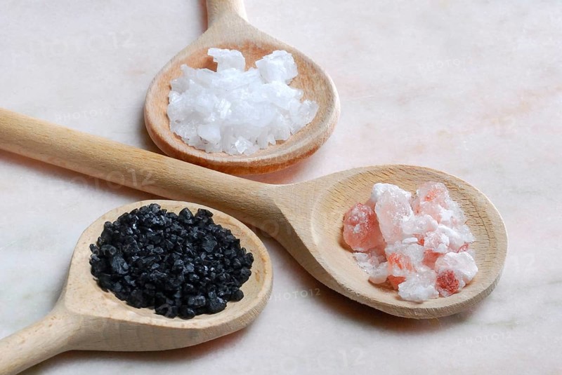 Different kinds of salt on wooden spoons