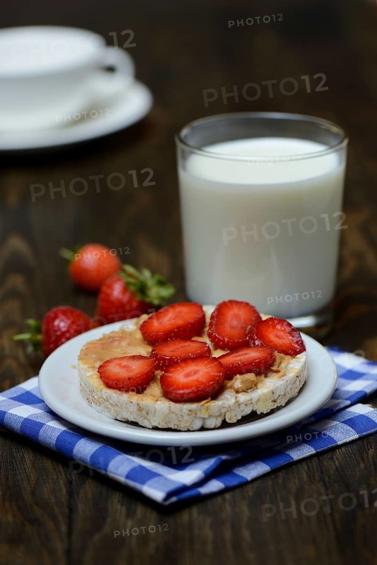 Corn and rice waffle topped with strawberries and peanut butter