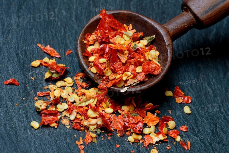 Dried chili peppers with wooden spoon