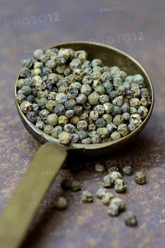 Green malabar pepper in brass ladle