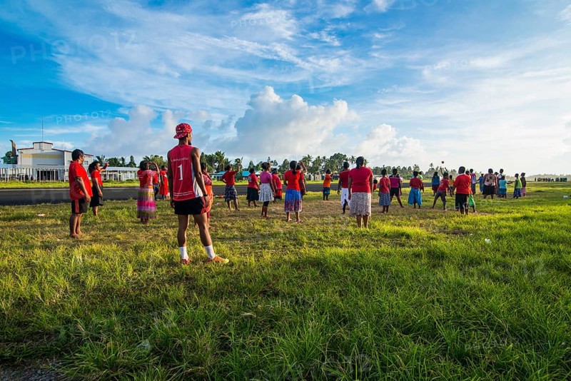 Villagers play volleyball together