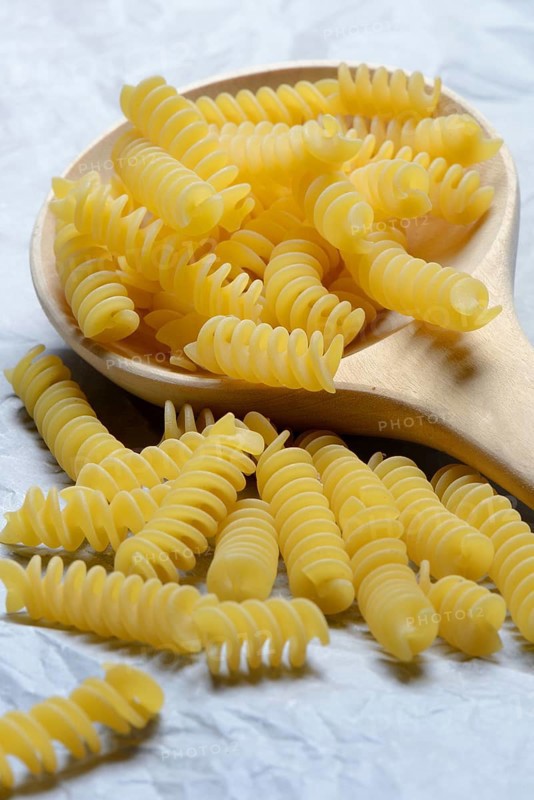 Spiral noodles in wooden ladle