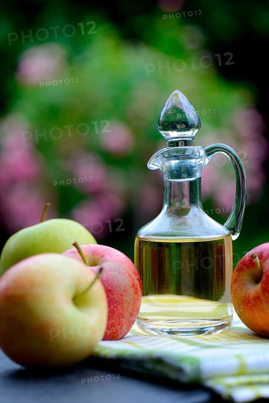 Carafe with apple vinegar and apples