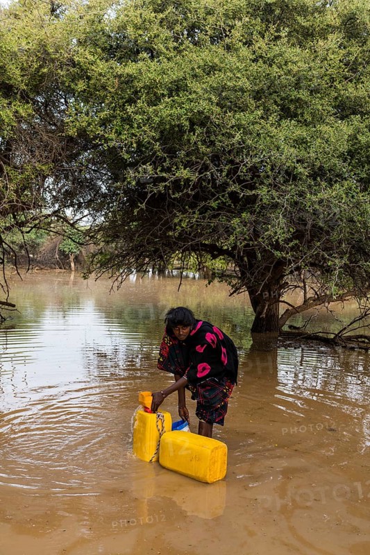 Woman fetches water in canisters