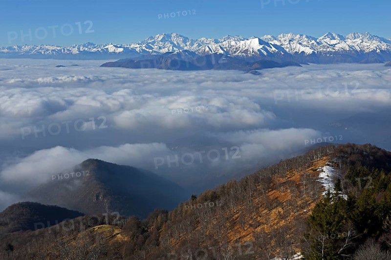 Snowy mountain range with Monte Rosa massif rising above sea of clouds