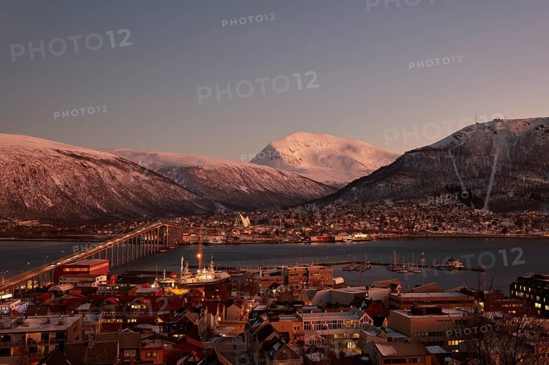 View of the harbour and the city with Tromso Bridge and Ice Sea Cathedral