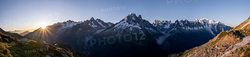Sun in front of mountains