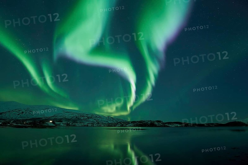Aurora borealis with water reflection in fjord