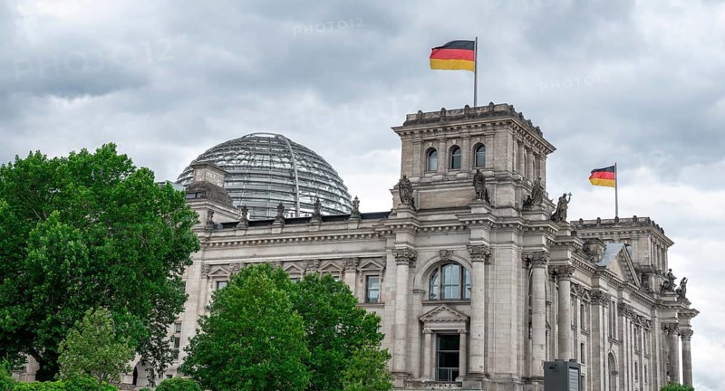 Reichstag building with waving German flag