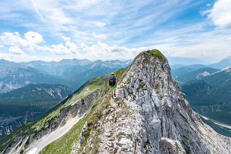 Mountaineer on a ridge on a secured via ferrata