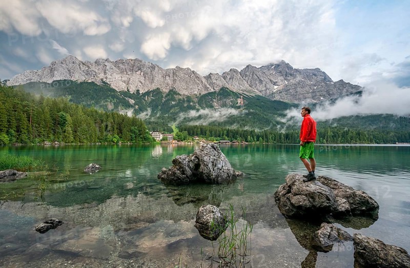 Young man standing on a rock on the shore