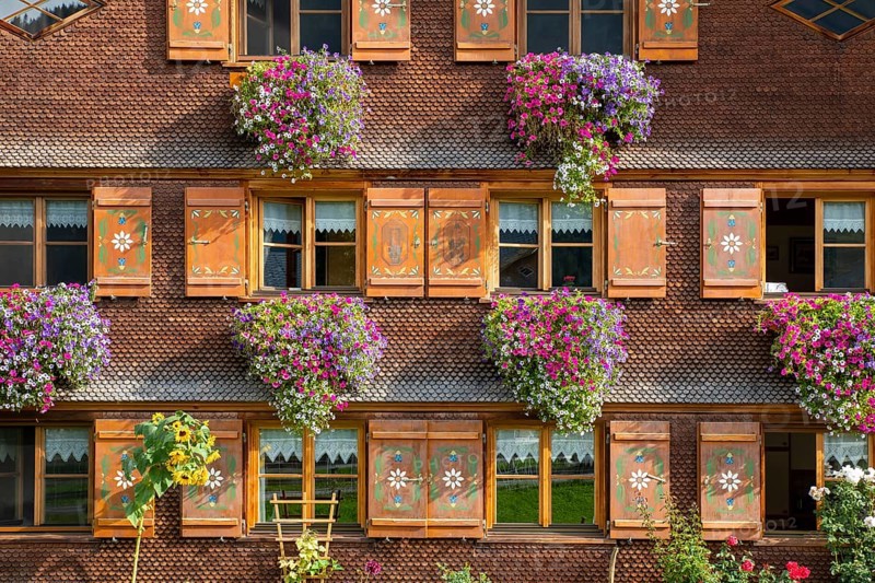 Facade of a Bregenzerwald house with flower decorations