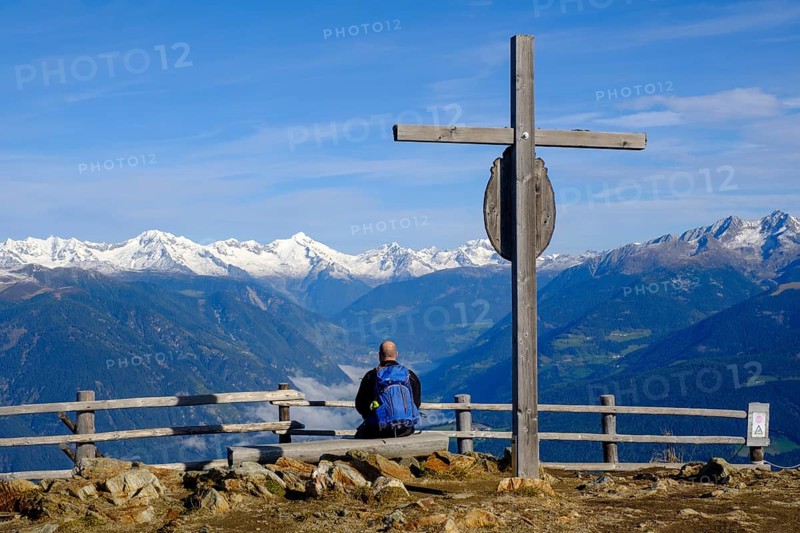 Hiker at the summit cross