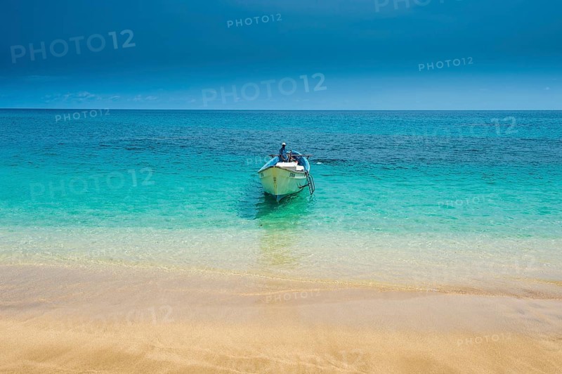 Little motorboat in the turquoise waters of Banana beach