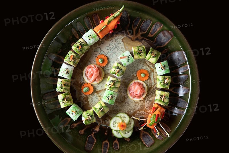Sushi decorated in form of a dragon on round plate
