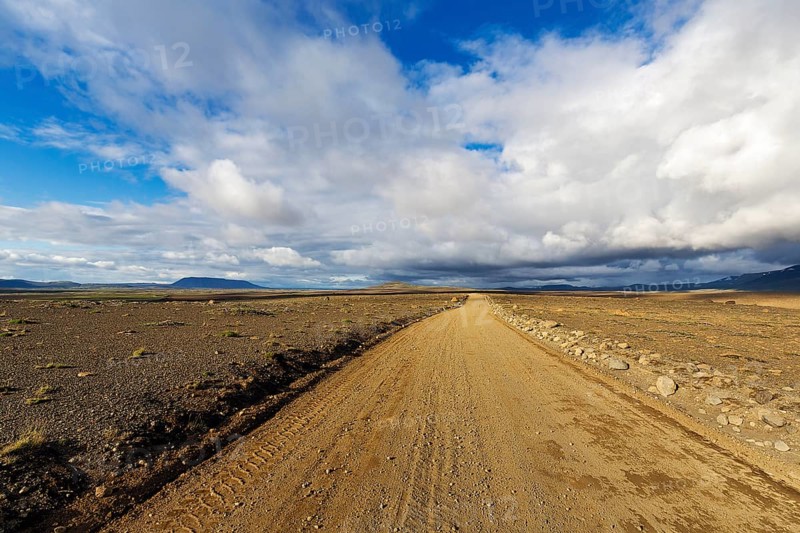 Lonely gravel road through volcanic landscape