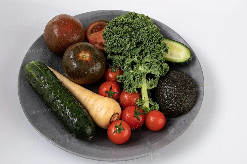 Fresh garden vegetables with water drops on a plate