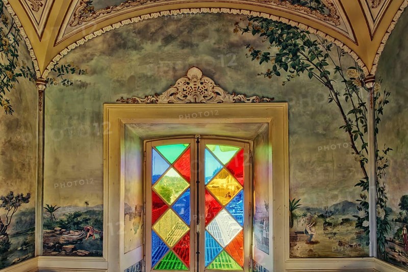Stained glass window and azulejos tiles in a garden pavilion