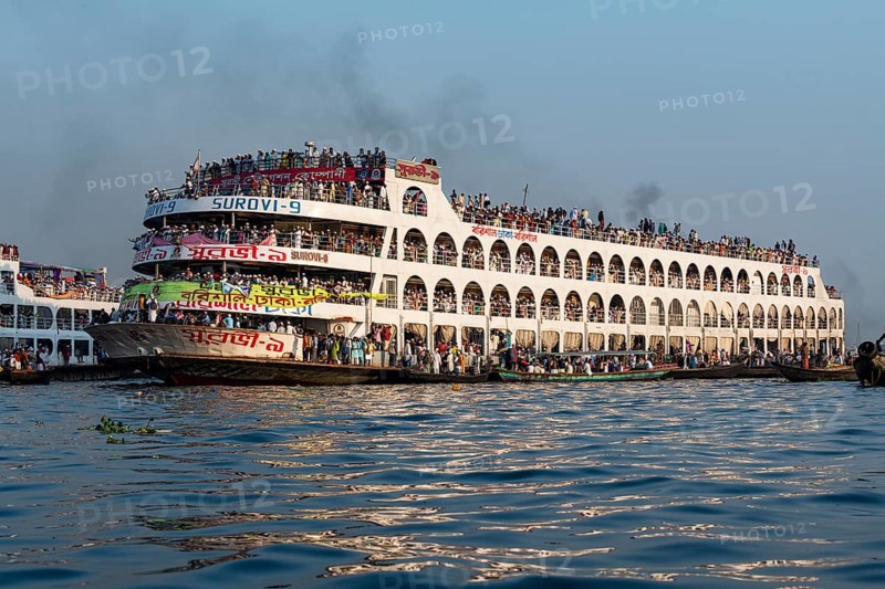 Overloaded passenger ferry with pilgrims on the Dhaka river