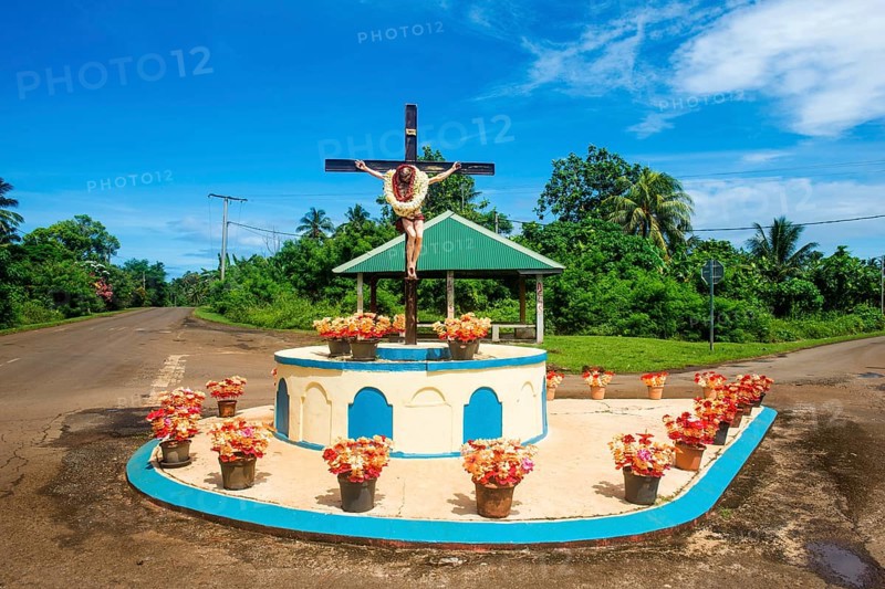 Christian statue at a road bend