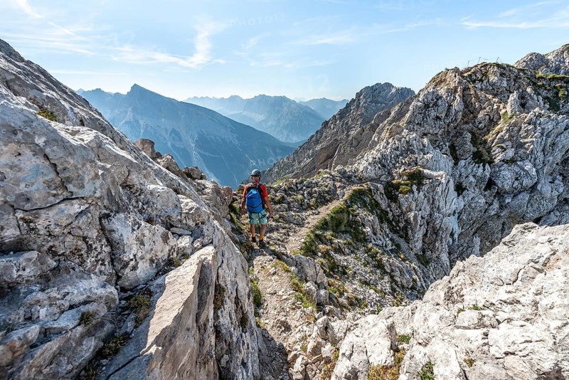 Mountaineer climbs a secured via ferrata