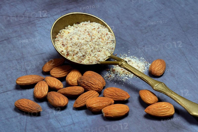 Ground almonds in brass ladle