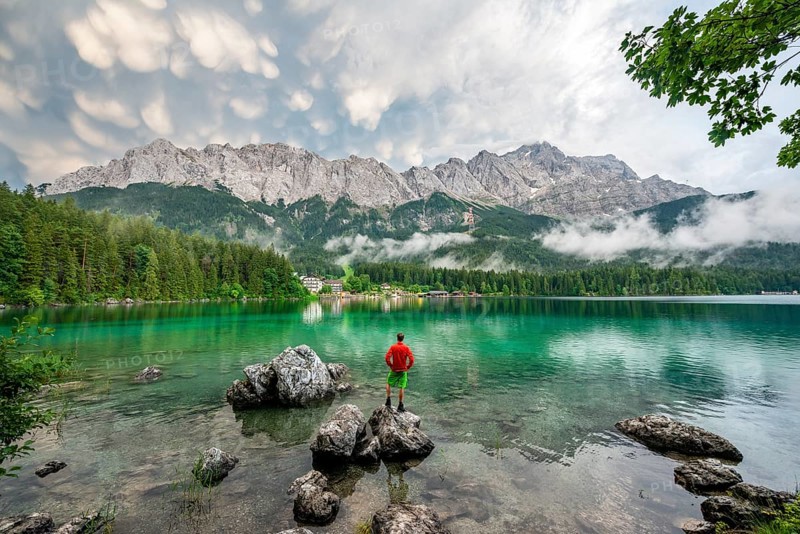 Young man standing on a rock on the shore