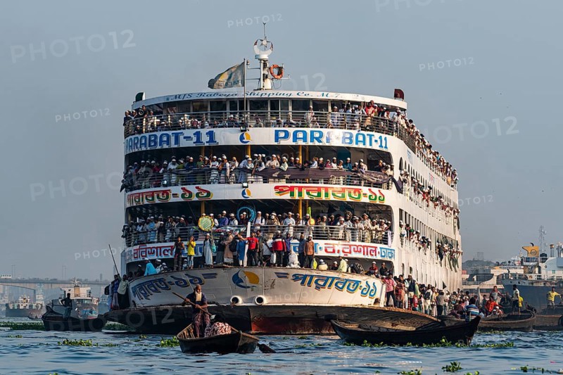 Overloaded passenger ferry with pilgrims on the Dhaka river