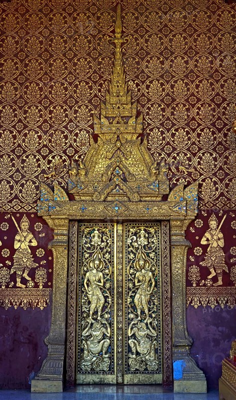 Splendid entrance door with carved half reliefs and decorative ornaments