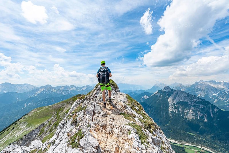 Mountaineer on a ridge on a secured via ferrata