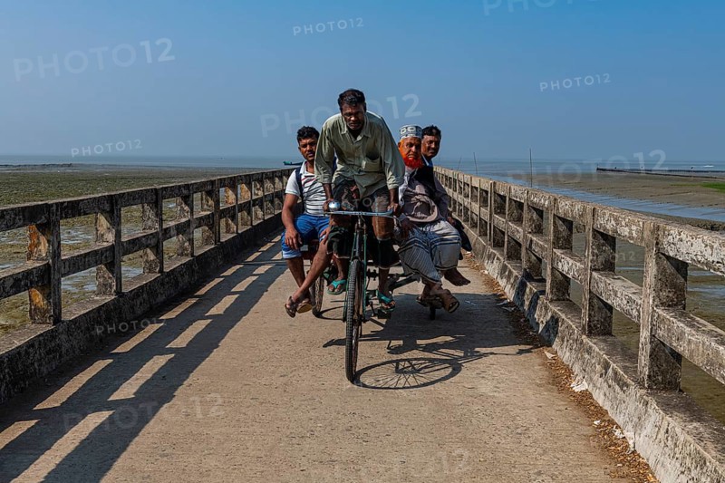 Rickshaw driver with several people on a Long pier in the Chittagong Ship Breaking Yard