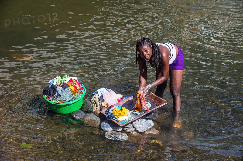 Woman washing her clothes in a river at the east coast of Sao Tome