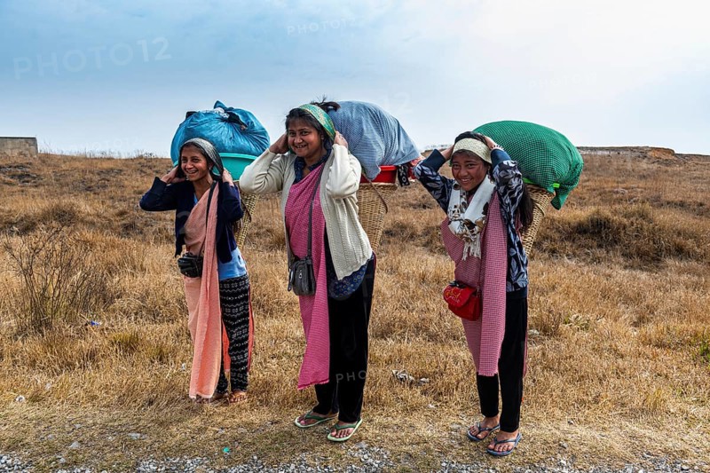 Khasi women carrying the laundry to a creek in a traditional basket