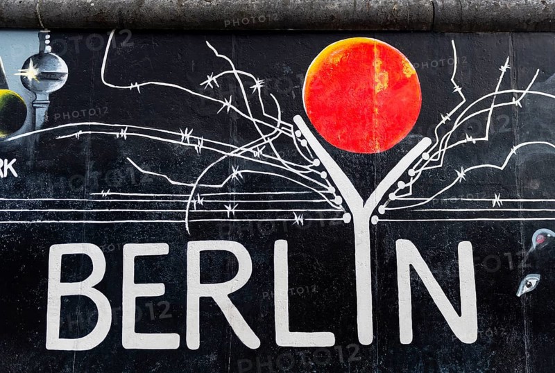 Mural Berlyn with lettering Berlin and symbolic wall with barbed wire