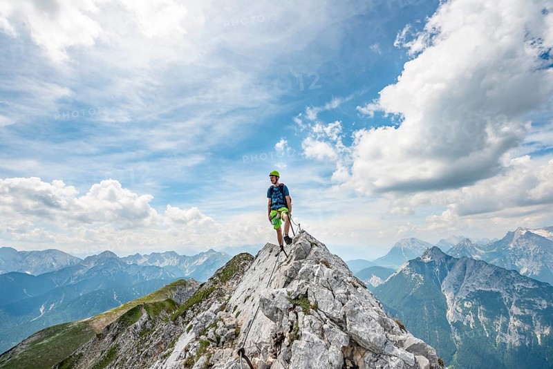 Mountaineer on a ridge on a secured fixed rope route