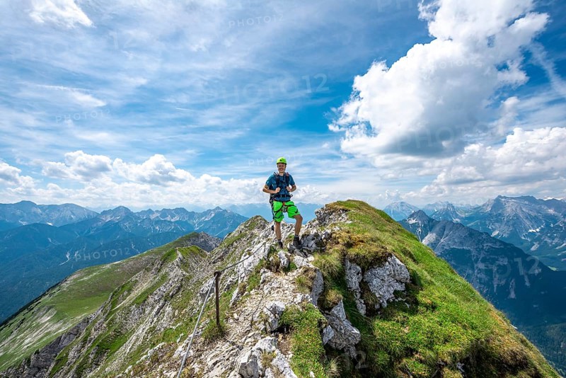 Mountaineer on a ridge on a secured fixed rope route