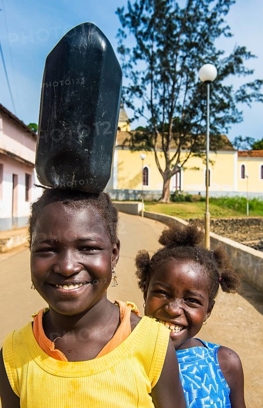 Friendly girls carrying a water canister