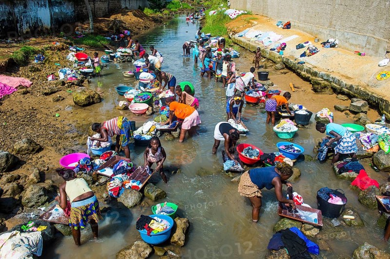 Women washing clothes in a river bed